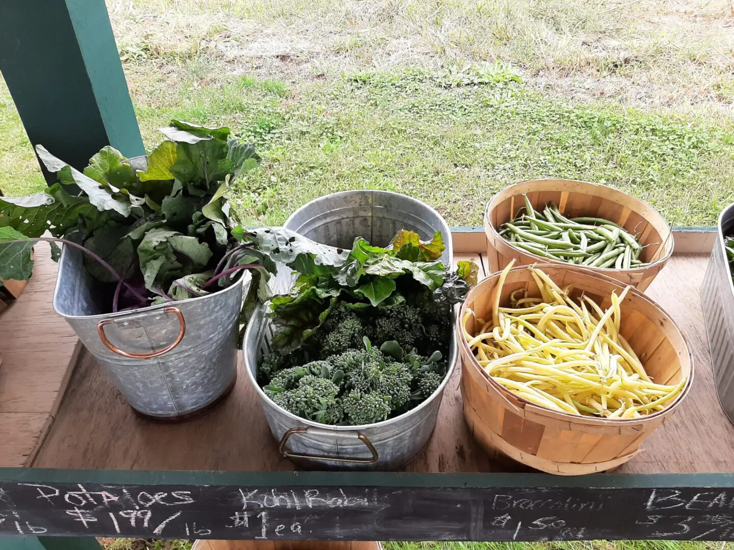 Metal containers and baskets filled with vegetables